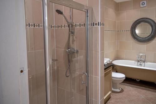 a bathroom with a shower and a toilet and a sink at Dunkeld House Hotel in Dunkeld