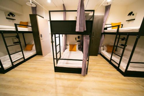 a room with four bunk beds in it at Jezreel Inn in Kaohsiung