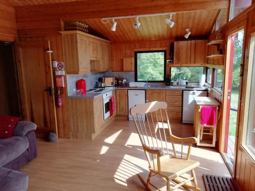 a kitchen and living room of a tiny house at Highland Lodge in Kilmorack
