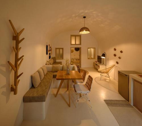 a living room with a couch and a table at Suite Home Santorini in Fira