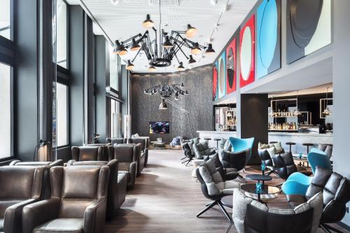 a salon with leather chairs and a waiting room at Motel One Basel in Basel