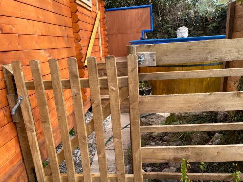 a wooden gate in front of a fence at Retro Lodge nr Dartoor with hot tub & opt sauna in Newton Abbot