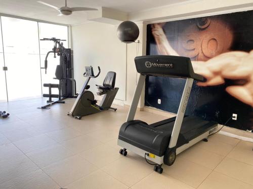 a room with a gym with a treadmill at Hotel Balneário in Poços de Caldas