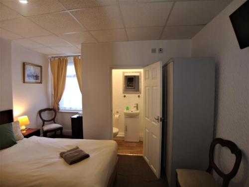 a hotel room with a bed and a bathroom at The Hopton Hotel in Blackpool