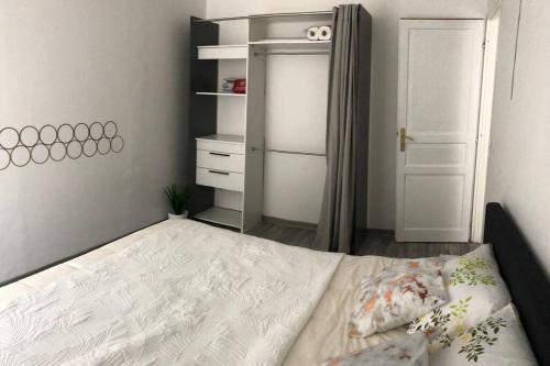 a small bedroom with a bed and a closet at Le Reflet de la Lune in Saint-Jean-de-Maurienne