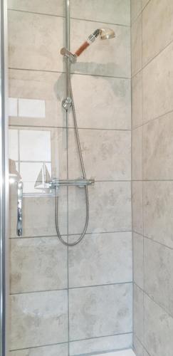a shower with a glass door in a bathroom at Heated Swimming Pool Looe Polperro Cornwall Holiday Home in Looe
