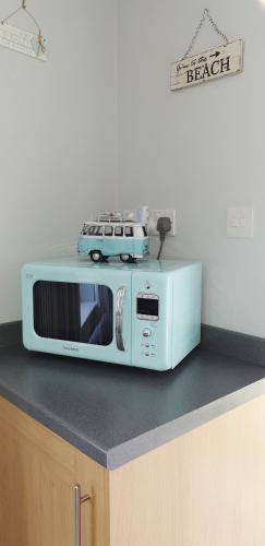 a microwave with a toy car on top of it at Heated Swimming Pool Looe Polperro Cornwall Holiday Home in Looe