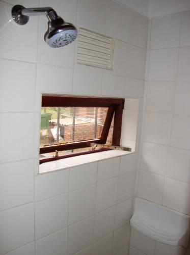 a bathroom with a window and a toilet at Trafalgar Chalets - Unit 3 in Southbroom