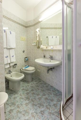a bathroom with a sink and a toilet at Hotel Rivamare in Lido di Jesolo