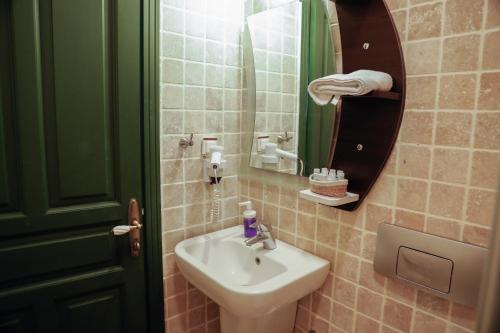 a bathroom with a sink and a mirror at Apaz Alaçatı Hotel in Alacati