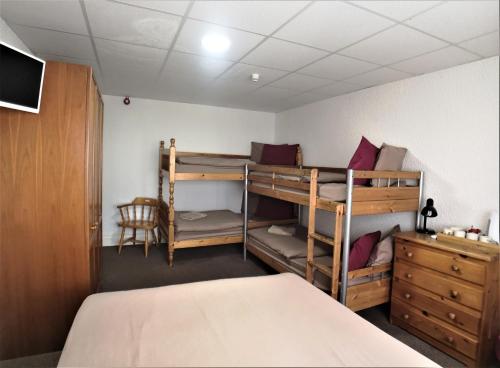 a bedroom with two bunk beds and a desk at The Hopton Hotel in Blackpool