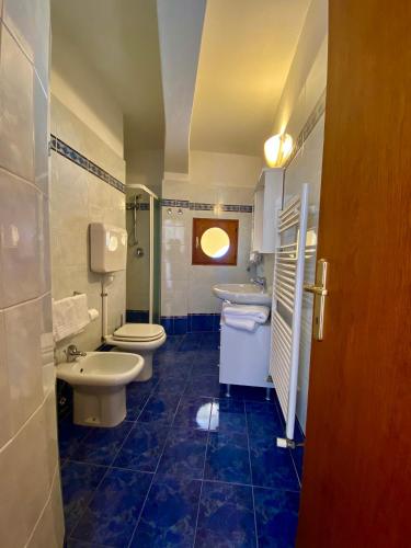a bathroom with two toilets and a sink at Camere Al Veliero in Gardone Riviera