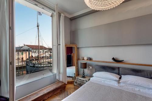 a bedroom with a bed and a large window at CasaDodici Boutique Hotel in Cesenatico
