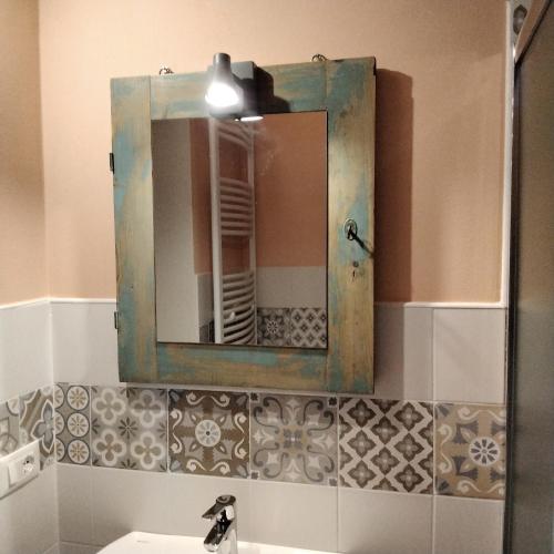 a mirror above a sink in a bathroom at casa Le Franche in Camaiore
