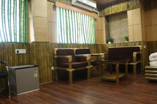 a waiting room with chairs and a table at Hotel Himalaya in Agartala