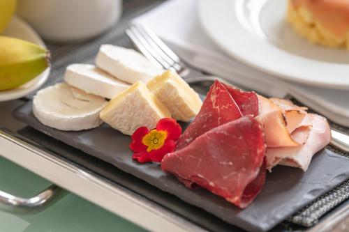 a plate of different types of cheese and meats at Swiss Luxury Apartments Geneva in Geneva