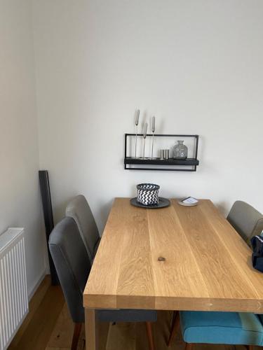 a dining room table with chairs and a wooden table at ZEITraum1 Gummersbach in Gummersbach