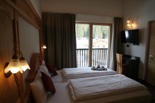 Postel nebo postele na pokoji v ubytování Alpen Hotel Vidi