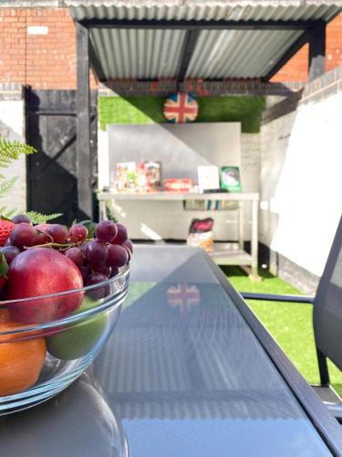 a bowl of fruit sitting on top of a table at The Baltic Townhouses by Serviced Living Liverpool in Liverpool