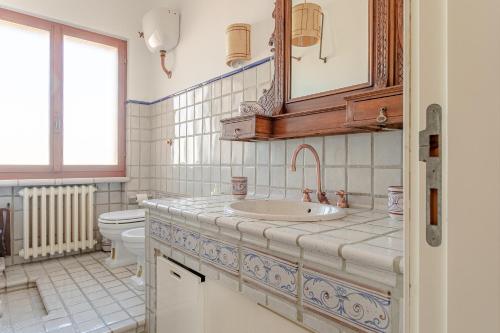 a bathroom with a sink and a toilet at RESIDENZE ARANCIO - Premium Villas in Giulianova