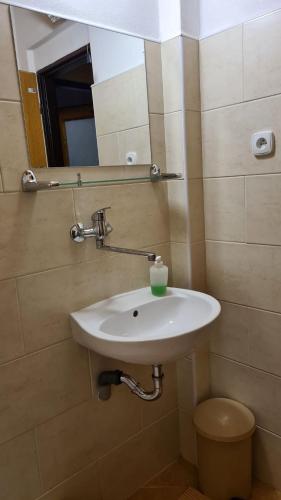 a bathroom with a white sink and a mirror at Penzión Zátoka in Liptovský Mikuláš