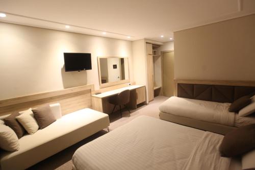 Ένα ή περισσότερα κρεβάτια σε δωμάτιο στο Hotel Alpin Llogara