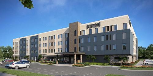 a large building with cars parked in a parking lot at Staybridge Suites - Portland by IHG in Portland