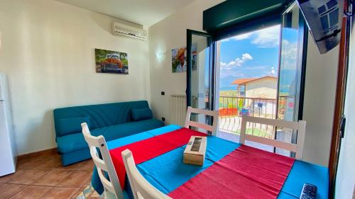 a room with a couch and a table and a window at Residence Bellavista in Manerba del Garda