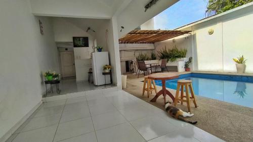 a dog laying on the floor next to a swimming pool at Casssa Vlanca Hotel in Palenque