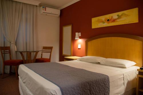 Hotel Exclusivo tesisinde bir odada yatak veya yataklar