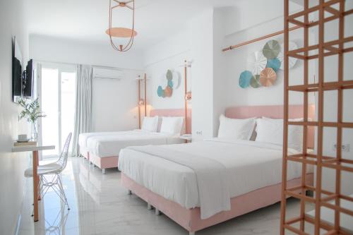 a bedroom with two beds and a ladder at Nama Boutique Hotel in Tinos Town