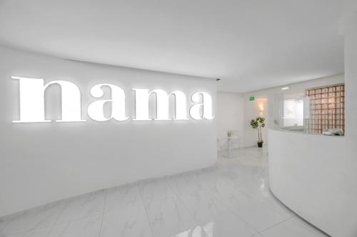 a white room with a large sign on a wall at Nama Boutique Hotel in Tinos Town