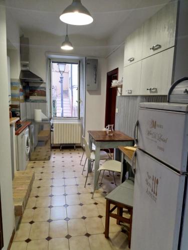 a kitchen with a table and a refrigerator at Gioscy in Citta' Sant'Angelo