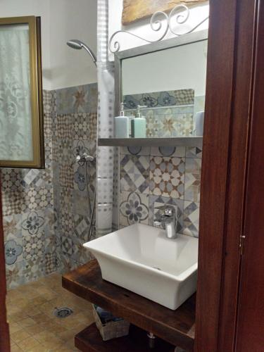 a bathroom with a white sink and a mirror at Gioscy in Citta' Sant'Angelo