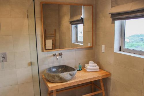 a bathroom with a sink and a glass shower at Villa dei Venti in Qala