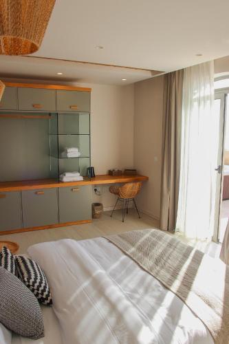 a bedroom with a bed and a desk in it at Villa dei Venti in Qala