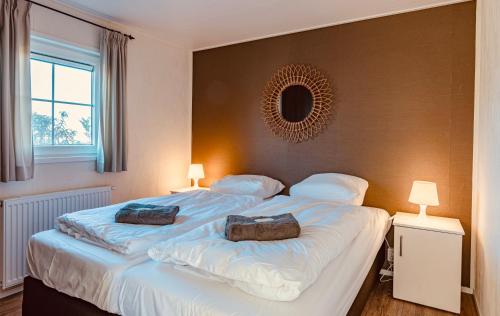 a bedroom with a large bed with two bags on it at Chalet park Kroondomein Giethoorn in Giethoorn