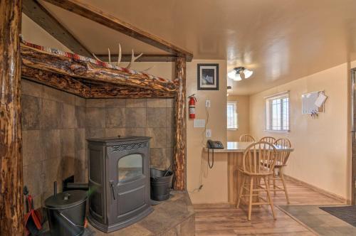 a living room with a wood stove and a table at Cozy Home with Canyon Views 2 Mi to Grand Staircase in Henrieville