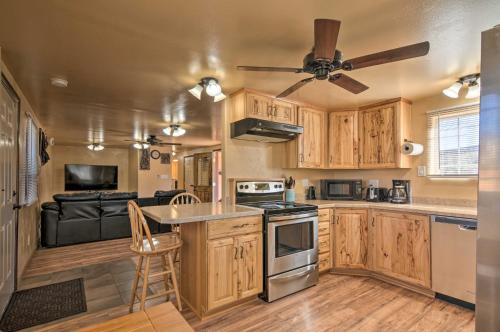 a kitchen with wooden cabinets and a ceiling fan at Cozy Home with Canyon Views 2 Mi to Grand Staircase in Henrieville