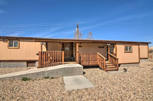 a home with a porch and a house at Cozy Home with Canyon Views 2 Mi to Grand Staircase in Henrieville