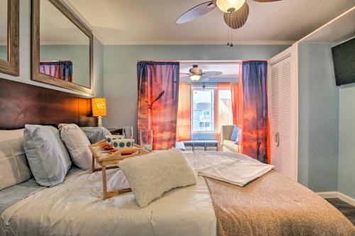 a bedroom with a large white bed with a table at 1 Mi to Beach Waterfront Retreat in Ocean City in Ocean City