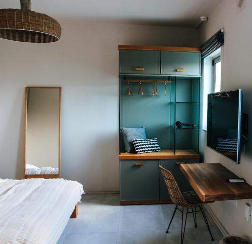 a bedroom with a desk and a bed and a table at Villa dei Venti in Qala