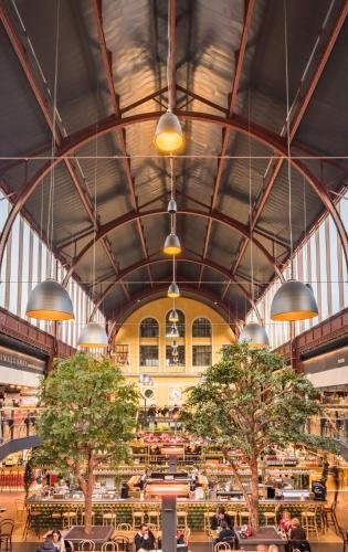 un grand bâtiment avec des tables et des arbres dans l'établissement Appartement 3 pièces Nice Hypercentre, à Nice
