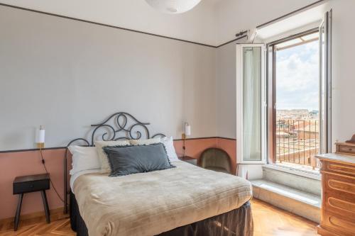 a bedroom with a bed and a large window at Rome at your feet in Rome