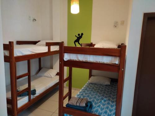 a room with three bunk beds with a monkey on the wall at Rio 222 Hostel in Rio de Janeiro