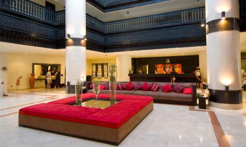 a large living room with a red couch in the middle at Royal Decameron Tafoukt Beach Resort & Spa - All Inclusive in Agadir