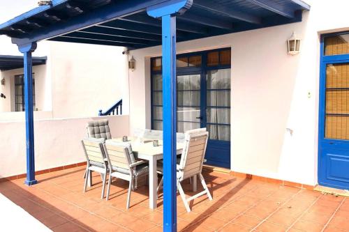 a table and chairs under a pergola on a patio at Casa Esperanza, 2 Bedroom Duplex Puerto Calero in Puerto Calero