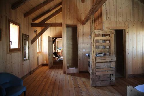 a large room with wooden walls and wooden floors at La Grande Marguerite in Les Fourgs
