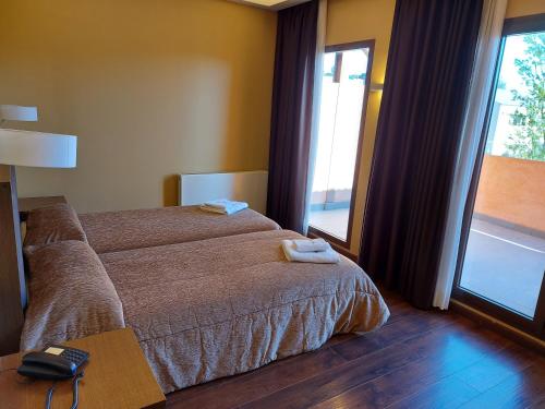 a bedroom with a bed with two towels on it at Fuente del Miro in Valderrobres