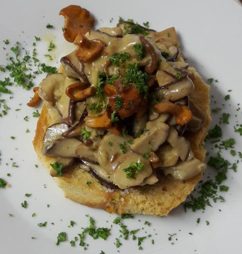a piece of food with mushrooms and gravy on a plate at Chanteloup, Maison d'hotes - Halleux in Halleux